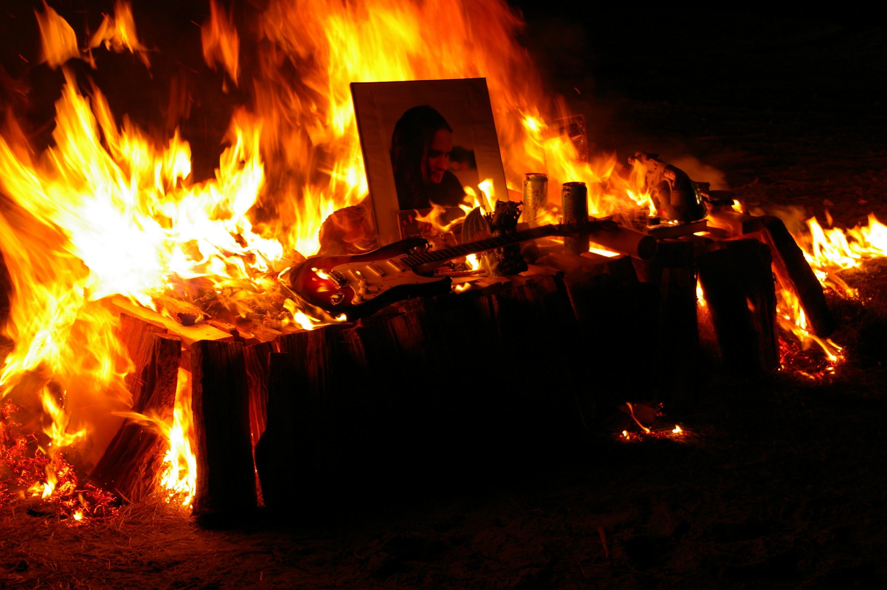 Flaming pyre and Joe's memorial photo